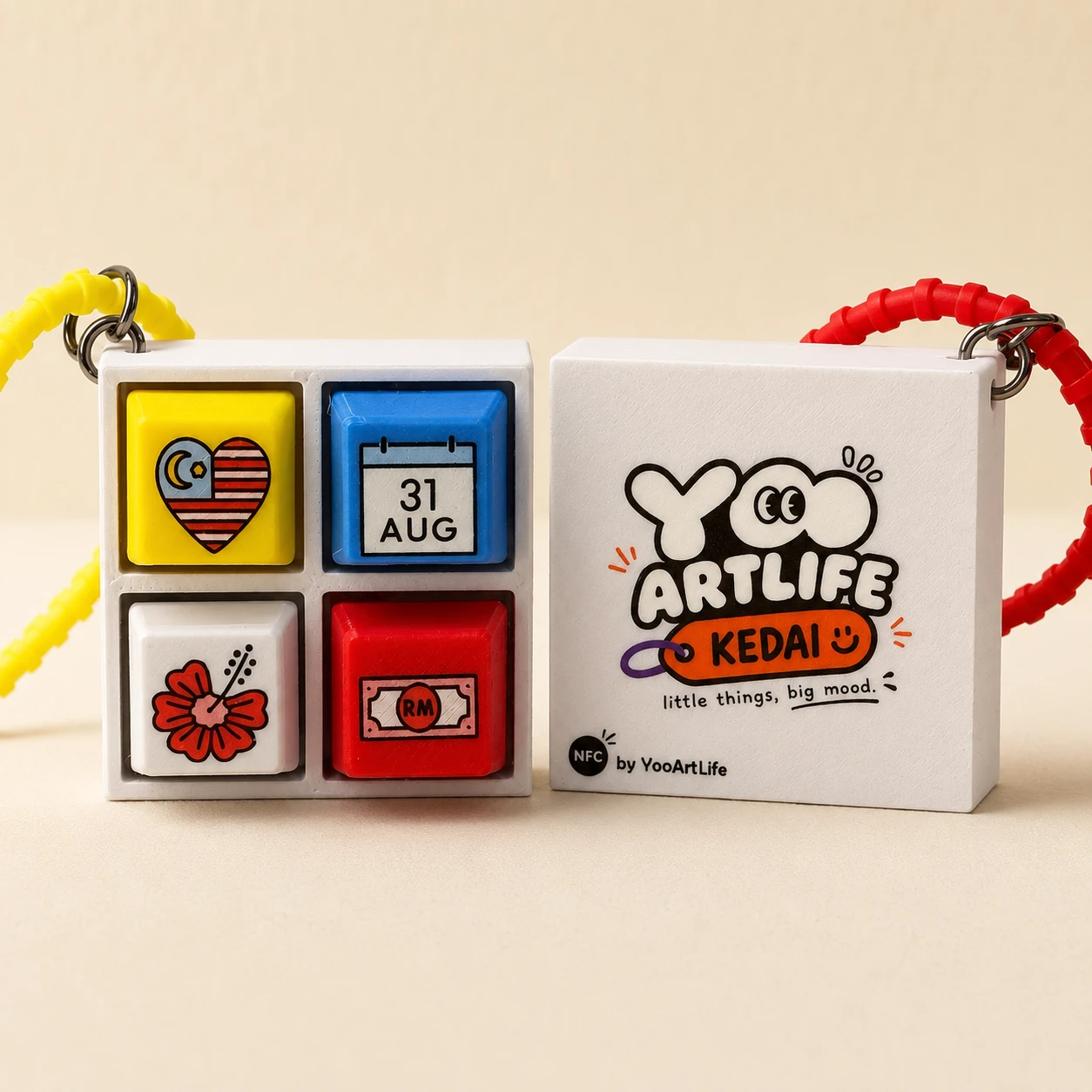 Two YooArtLife Keycap Clickers: the front with four Merdeka keycaps in a white 2 by 2 base, and the back printed with the YooArtLife Kedai logo and NFC by YooArtLife